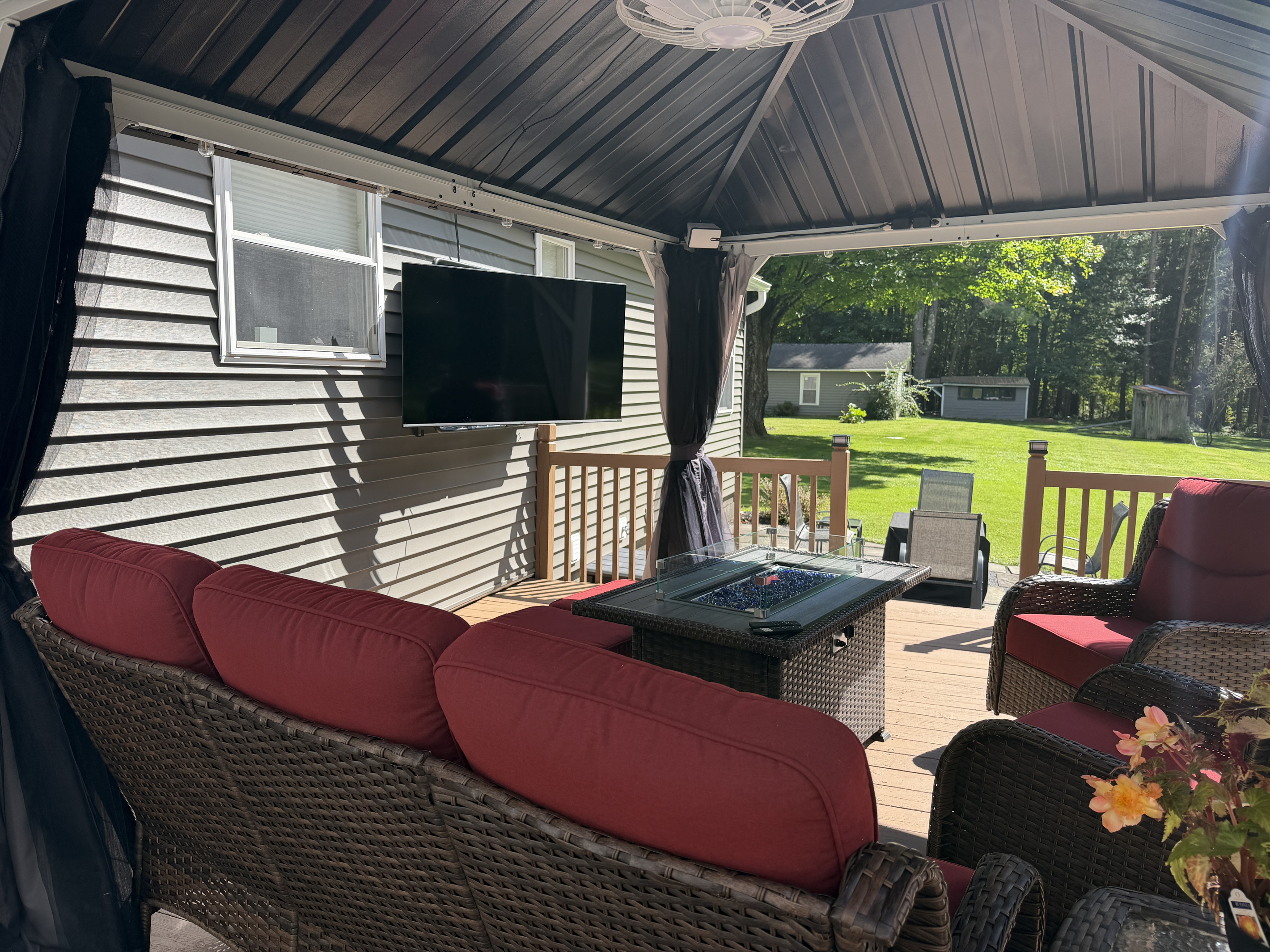 Back porch seating with outdoor SmartTV and gas fire table