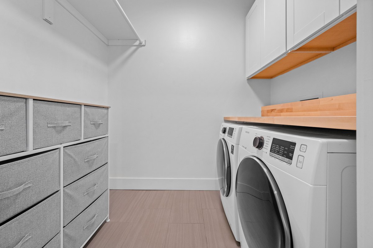 Convenient second-floor laundry room with full-size washer and dryer.