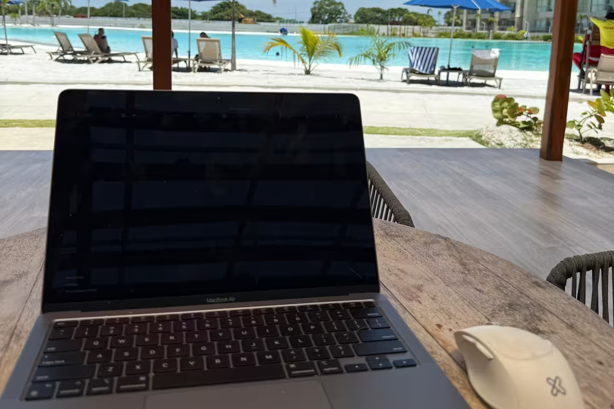 La configuración para laptop ofrece vistas directas a la piscina de la laguna turquesa, convirtiendo cualquier momento de trabajo o descanso en una experiencia destacada tipo resort.