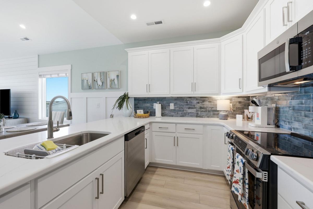 Cook with ease in the fully equipped kitchen featuring generous counter space and modern finishes