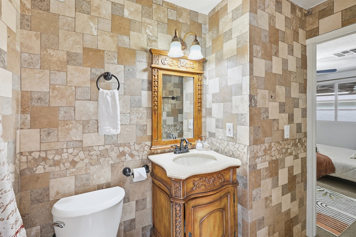 Refresh in this beautifully tiled walk-in shower with elegant stonework and serene garden views just steps away.
