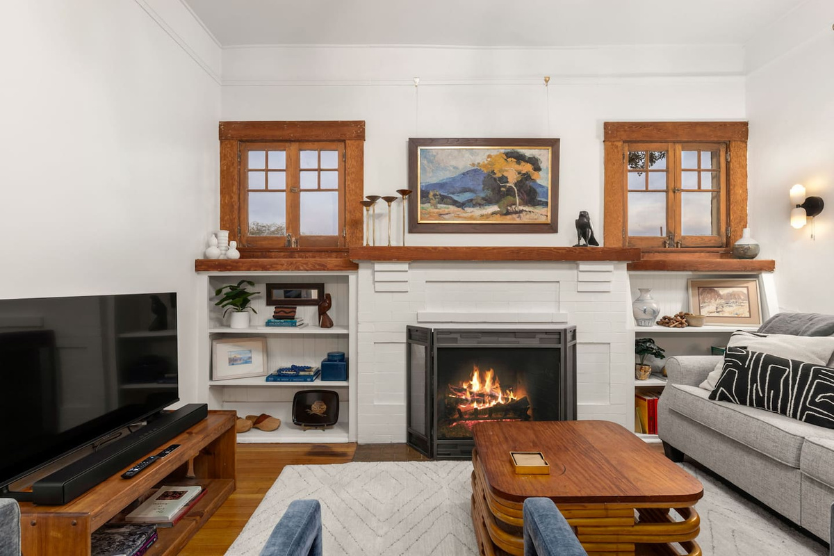 cozy living room with decorative fireplace and new TV