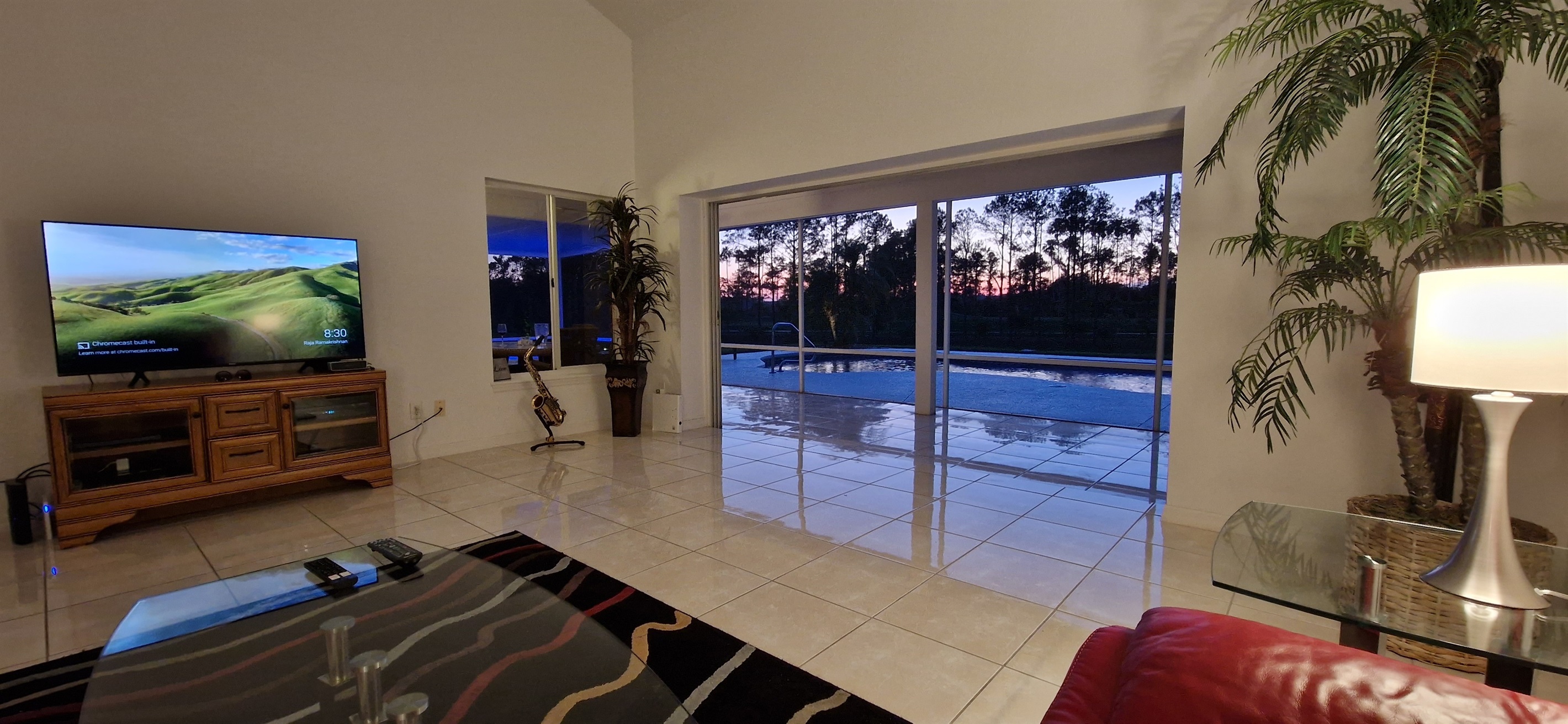 Living room view of pool and sunset