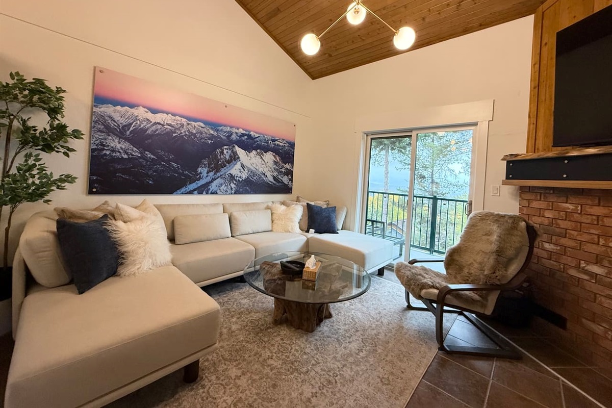 Balcony Access: The living room offers direct access to the private balcony, perfect for morning coffee while overlooking the stunning Rocky Mountains.