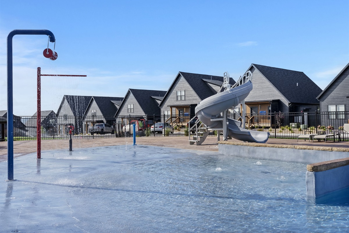 Outdoor pool with slide and splash pad!