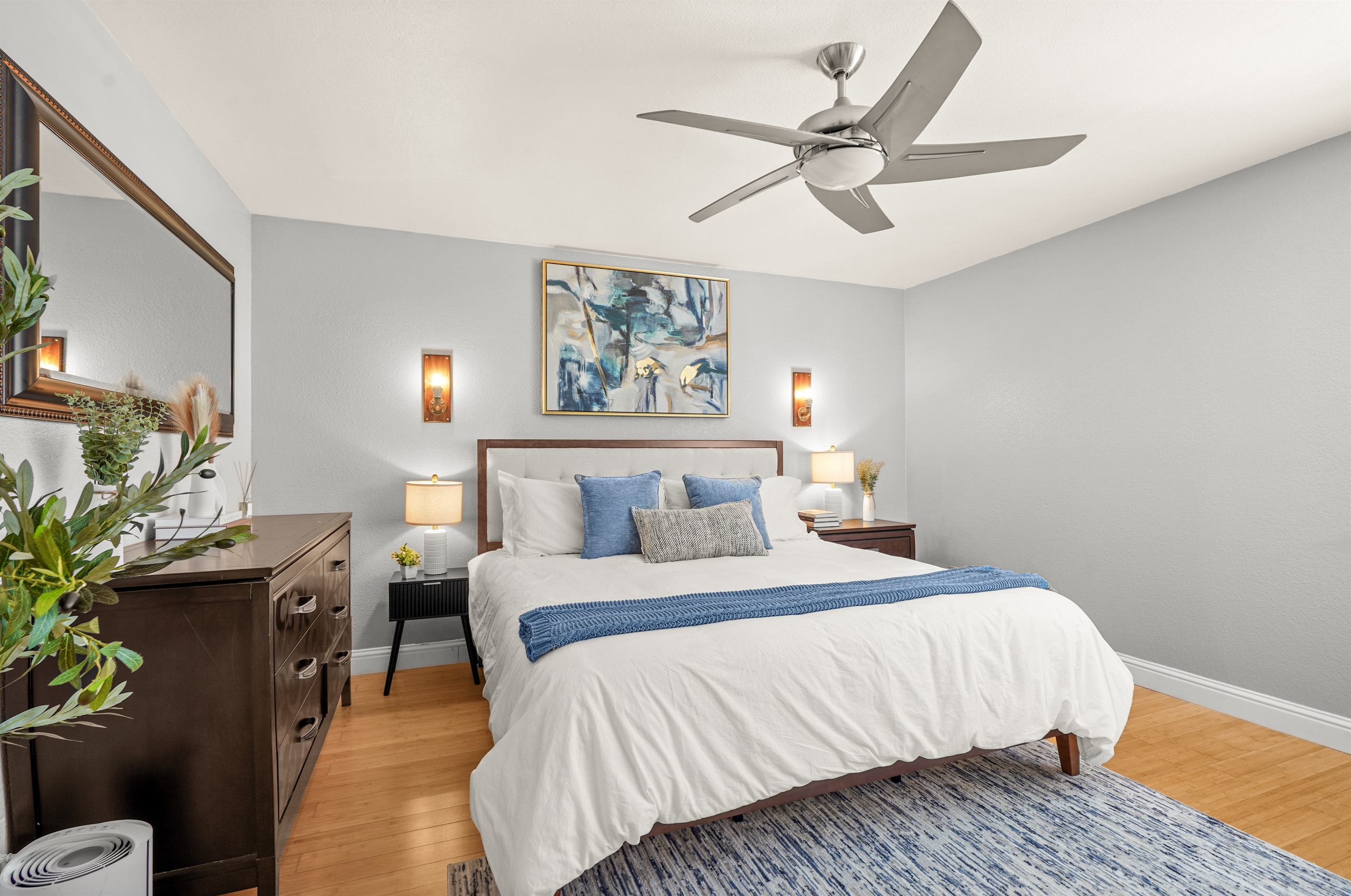 Spacious upstairs primary suite featuring a king bed and ensuite bathroom with dual sinks.