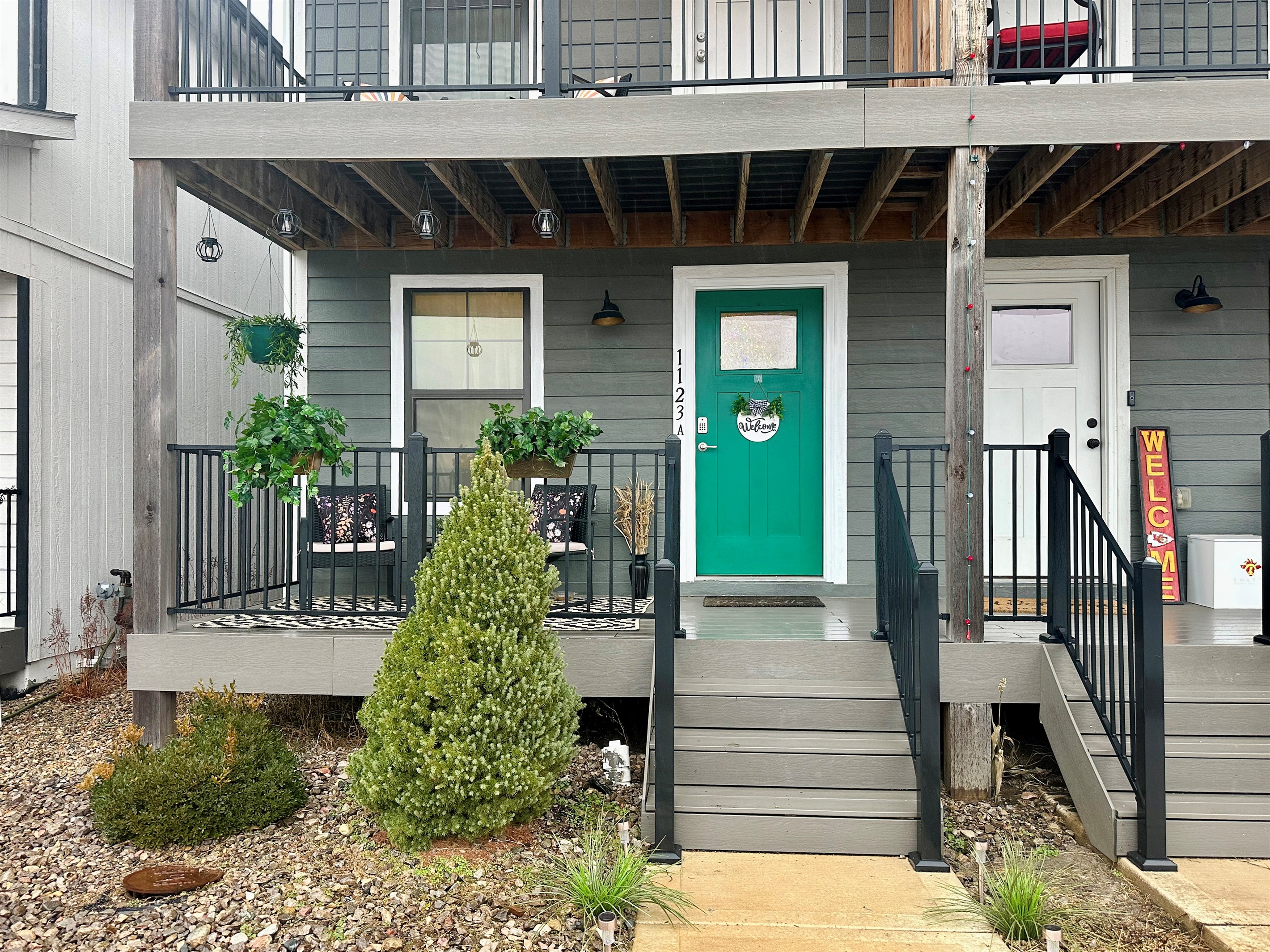 Front elevation showcasing the home’s clean lines, modern exterior, and private upper balcony.