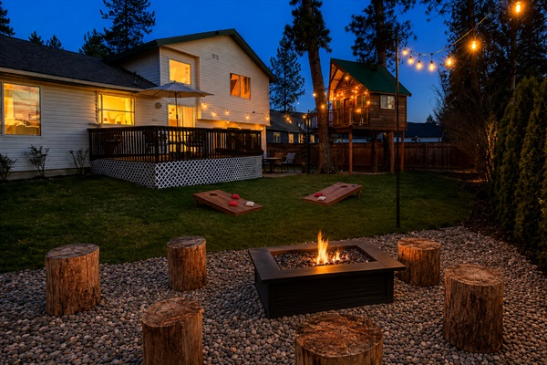Family-friendly backyard retreat with glowing treehouse, firepit, string lights, and games ~ perfect for making memories together
