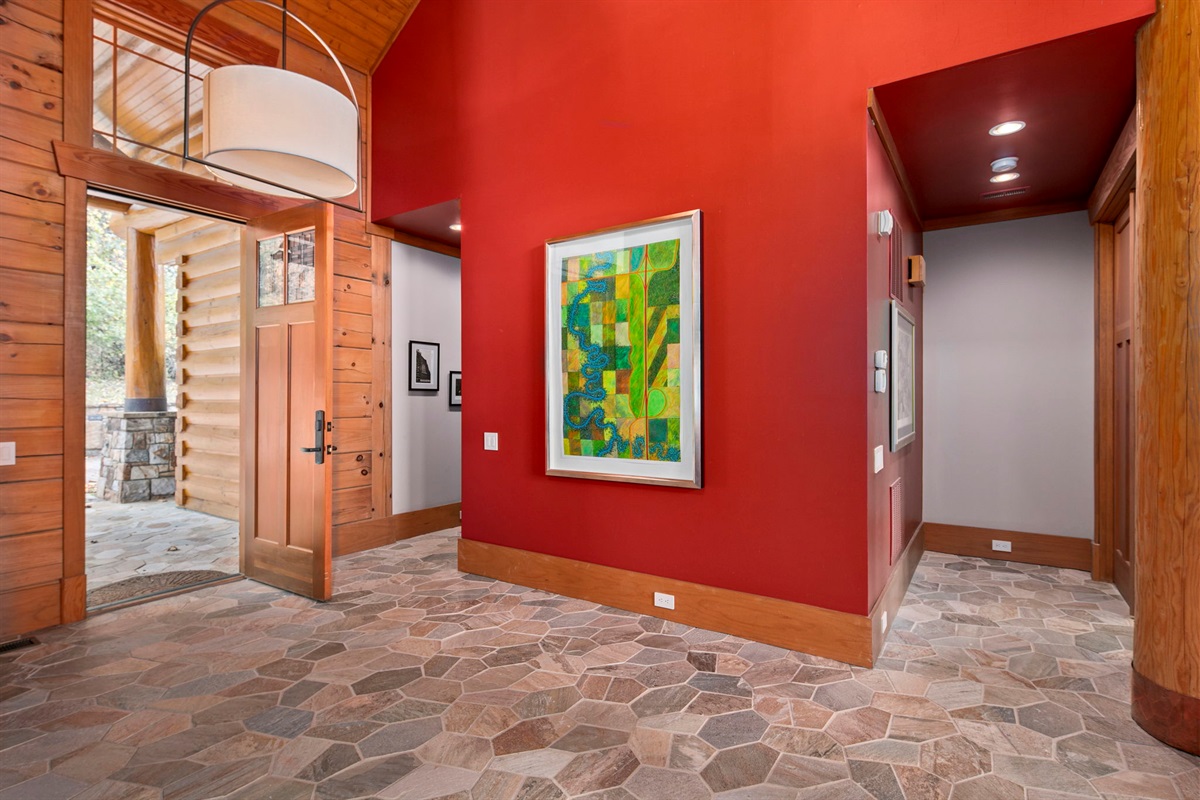 Grand entry way, vibrant colors, modern trim with warm feel all around
