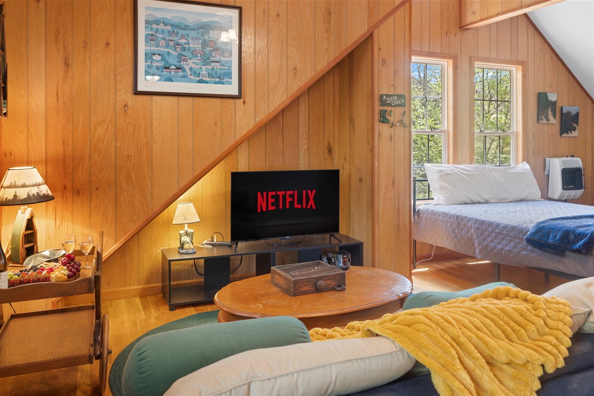 Cottage Living Area: Enjoy movie nights with a warm atmosphere and stunning views from your retreat!