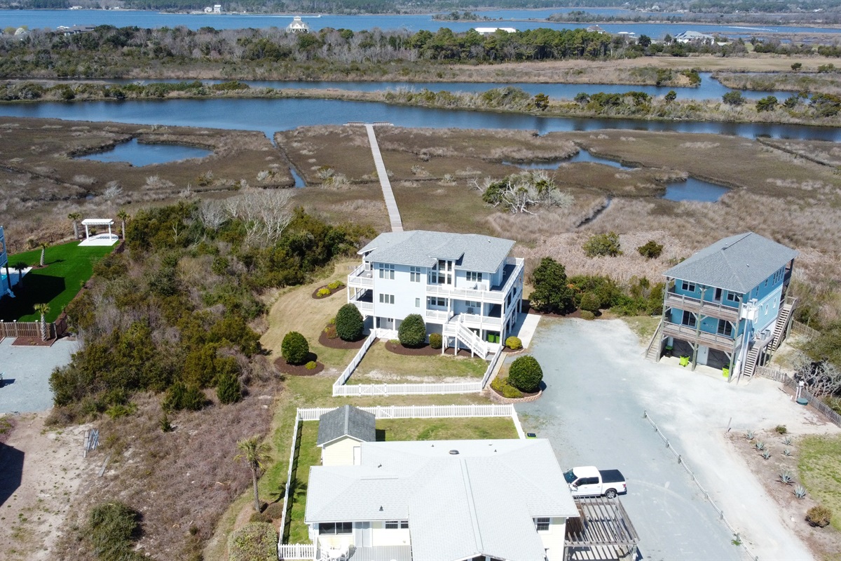 Aerial view of Soundside Solace with marsh and sound behind the home