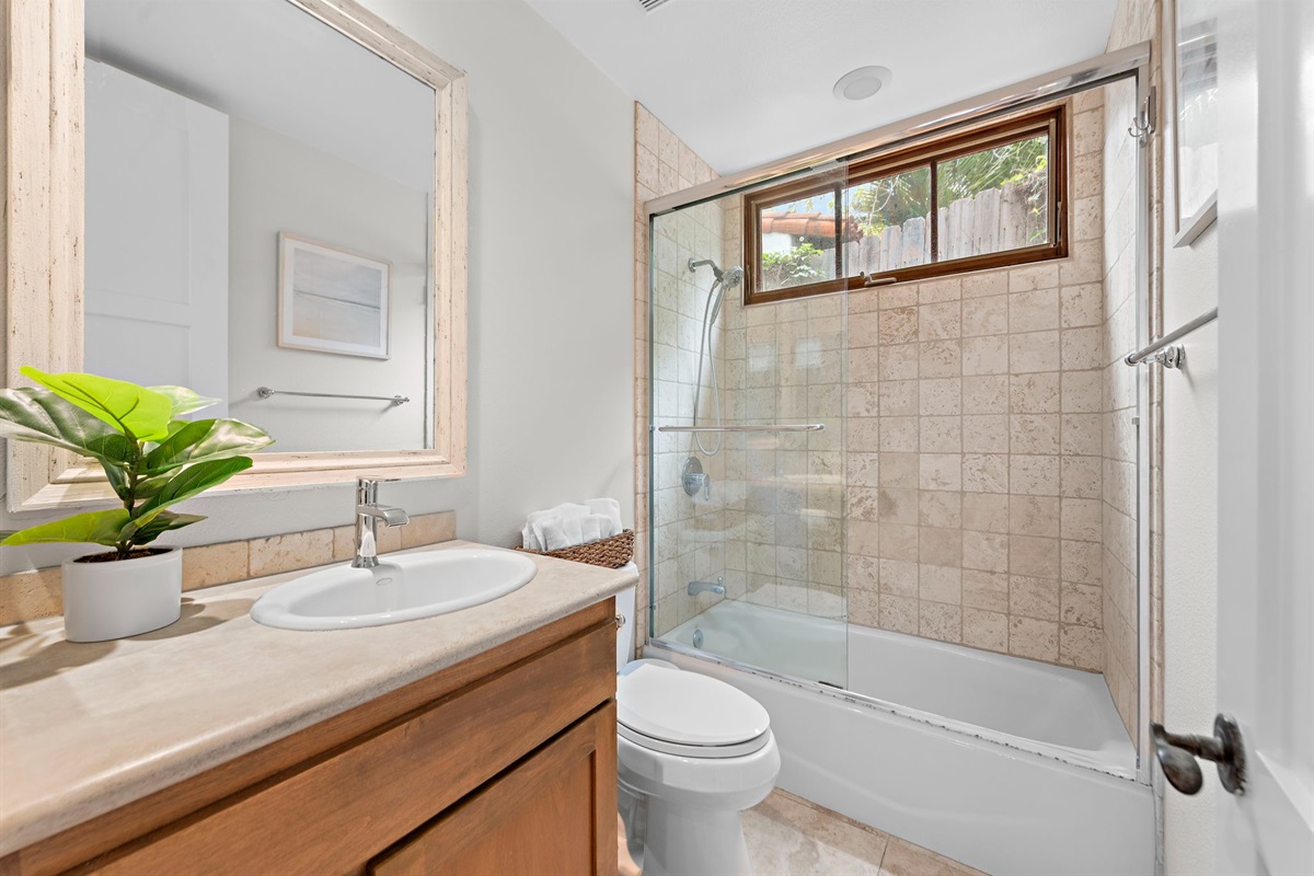 Our bright, clean hallway bathroom is also a full bathroom with a tub/shower and is fully equipped with soap, shampoo, and conditioner.