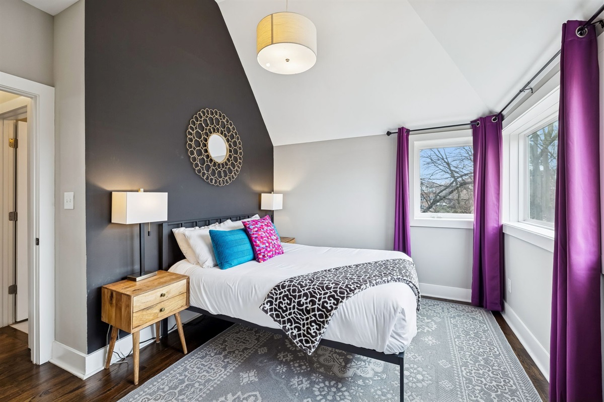 - Wake up to tree lined views & bold purple drapes that frame the sunlight perfectly - Soft pillows, clean lines, & a comfy bed make this space equal parts stylish & soothing - Whether it&rsquo;s morning light or afternoon naps, this corner is built for calm