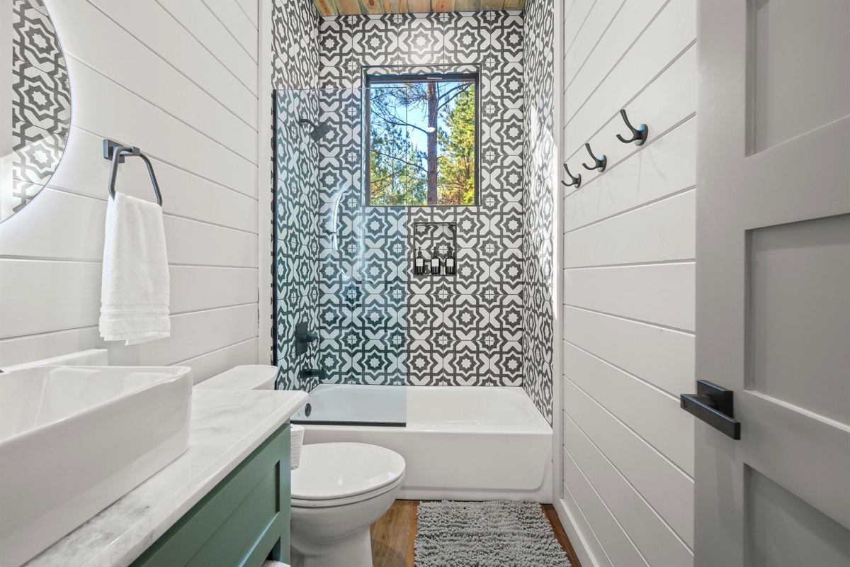 Even the smaller bathrooms are full of charm, blending patterned tile and modern finishes that make every detail feel intentional.