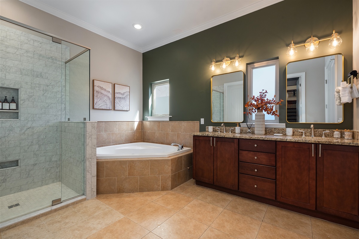 Large primary bathroom with soaking tub and walk-in shower - adds comfort and convenience to your stay