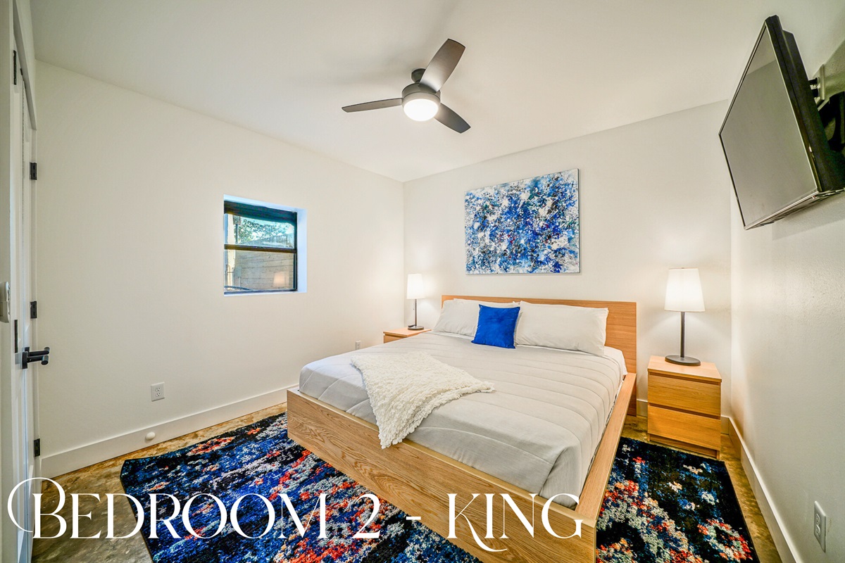 This king bedroom delivers minimalist comfort, pops of color, and restful vibes — a peaceful space to recharge by the lake.