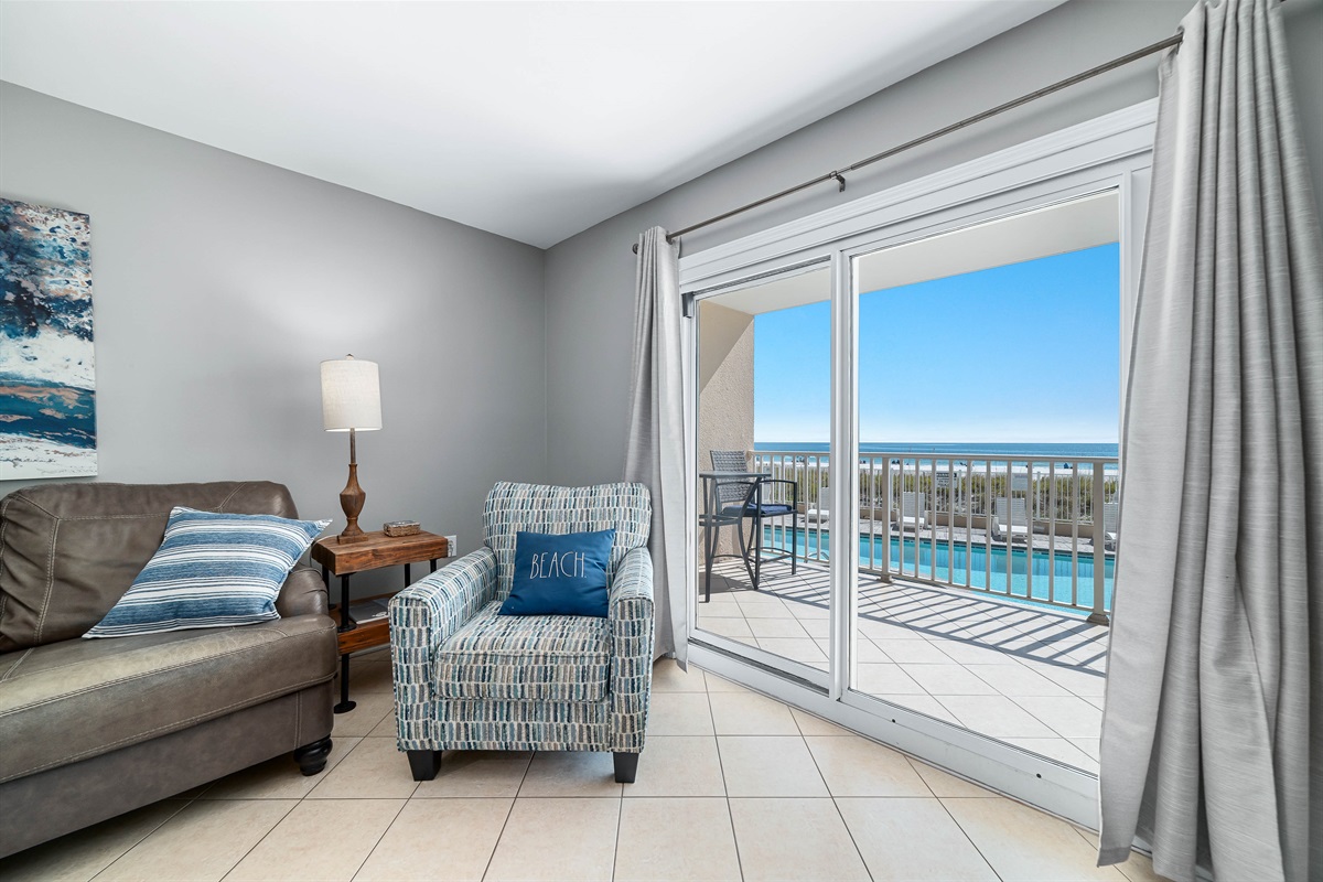 Maximize your comfort and sleeping arrangements with our versatile living area, showcasing a convenient sleeper sofa. Enjoy stunning panoramic ocean vistas right from your accommodation.