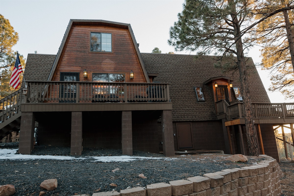 Poppywood Pines' distinctive gothic western A-frame architecture stands majestically among ponderosa pines in Show Low. This unique vacation rental offers covered parking and multiple outdoor spaces, perfect for your White Mountains escape near hiking, fis