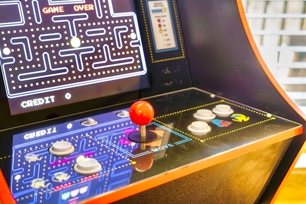 Here’s a detailed caption for the arcade game image, keeping it cozy and inviting:  "Get ready for game night with family and friends! Challenge each other to classic arcade fun and make memories filled with laughter and friendly competition."