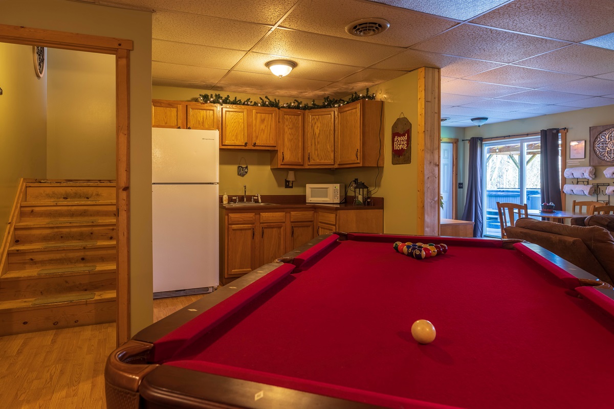 The lower-level game room includes a billiard table with kitchenette!