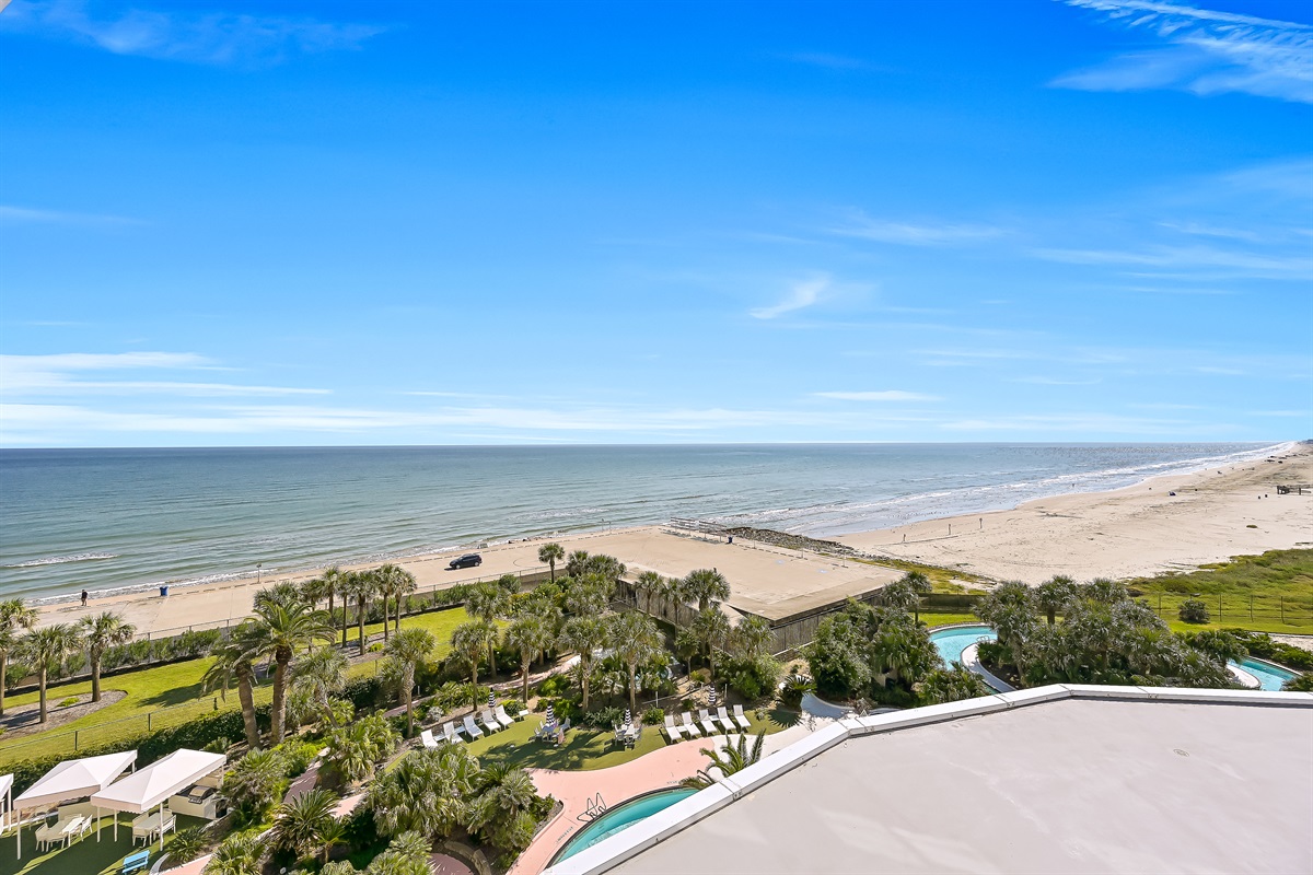 View looking at the beach and Seawall from the balcony.  Partial view of the Lazy River.