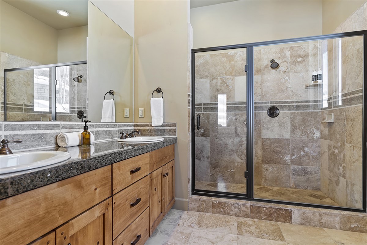 Primary ensuite bathroom with double vanity, walk-in shower, and a layout designed for comfort and convenience.