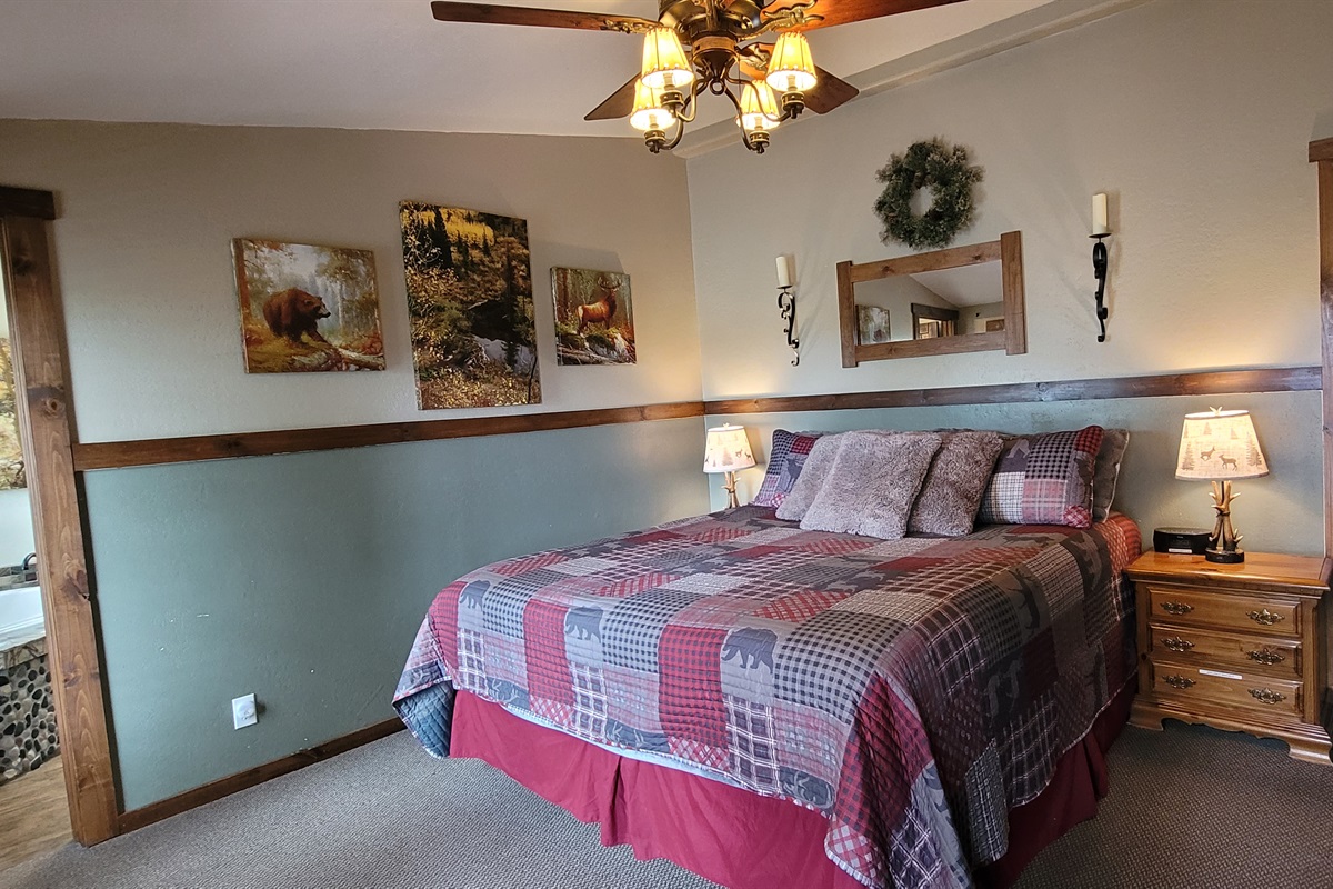 King size bed, smart TV, armoire and dresser for clothing storage.