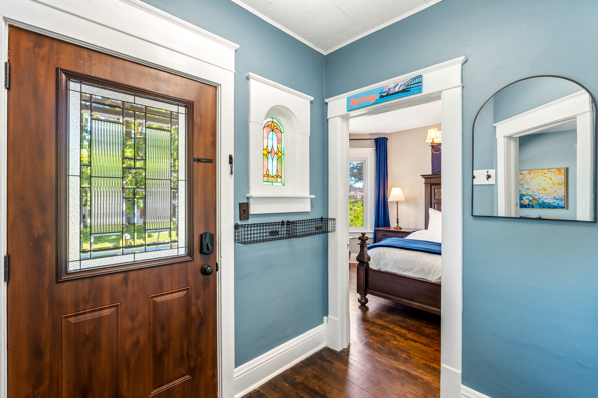 Welcome to Wanderer's Rest. A peek from our bright front entryway reveals the easy, seamless flow directly into the main-floor Sydney King bedroom.