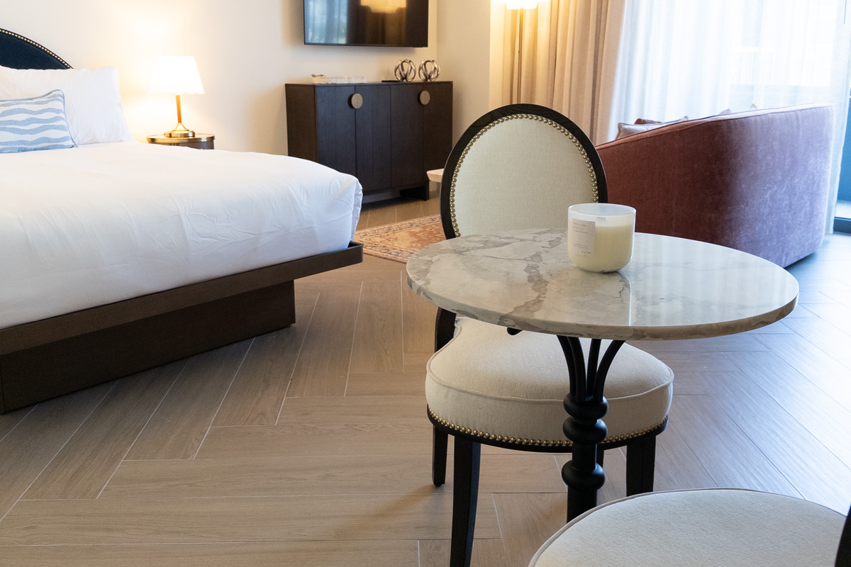 Bedroom and bistro nook in one &mdash; studio living with plush bed and marble cafe table