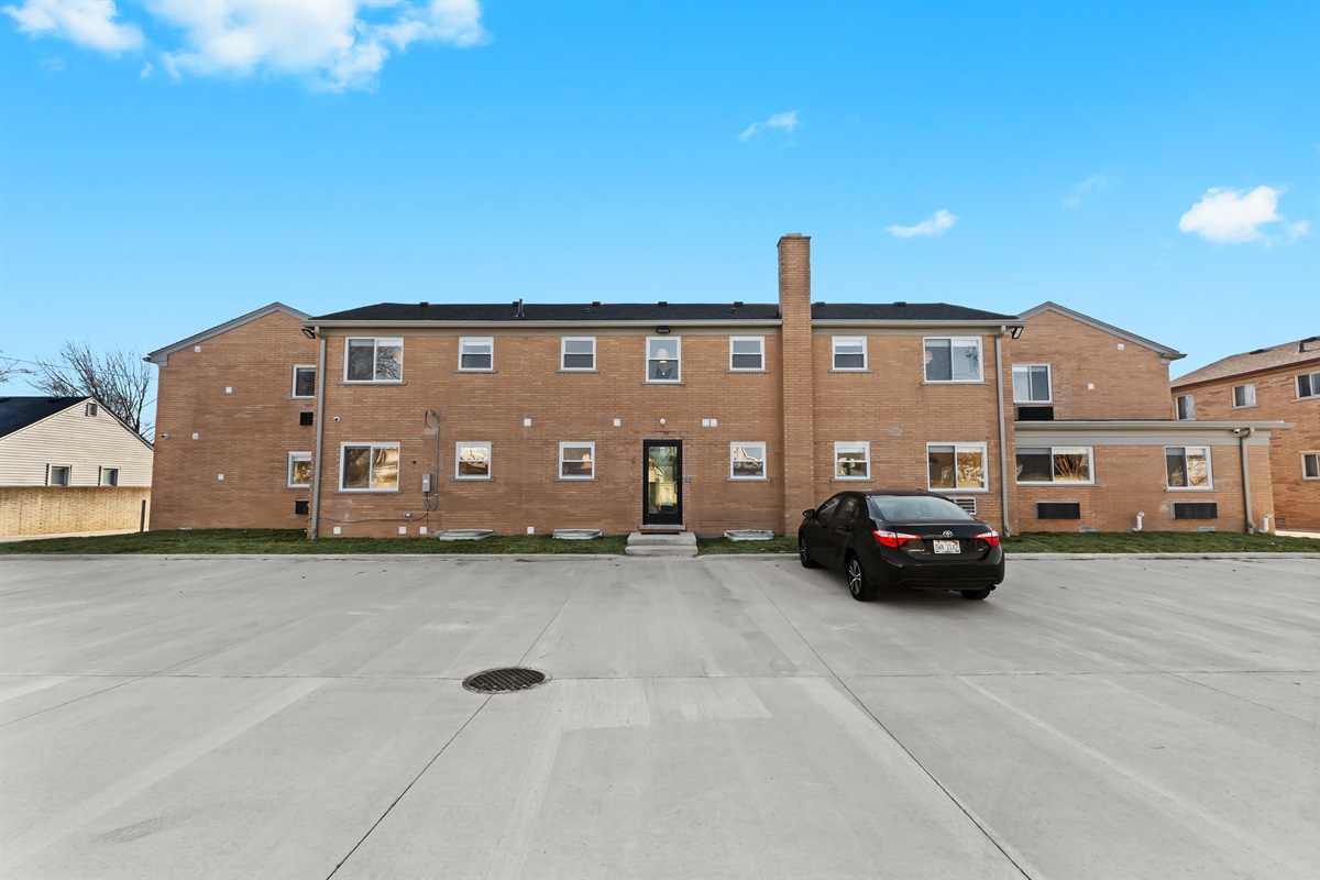 A well-maintained brick building with easy parking and a welcoming entrance, offering a quiet, convenient place to call home during your stay.