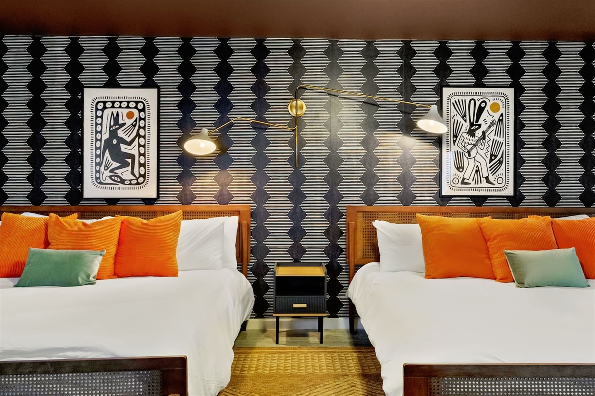 This vibrant main-floor bedroom features two king beds and blends bold style with ultimate comfort. Perfect for families, corporate teams, or friends on a getaway, it's the ideal spot to recharge after a fun-filled day in San Antonio.

