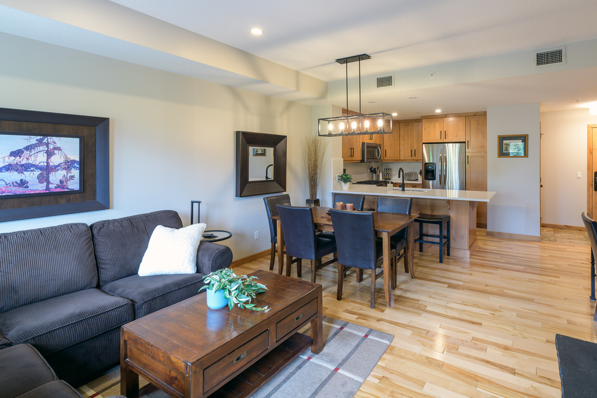 Looking towards the dining area and kitchen. Updated light fixtures and countertop.