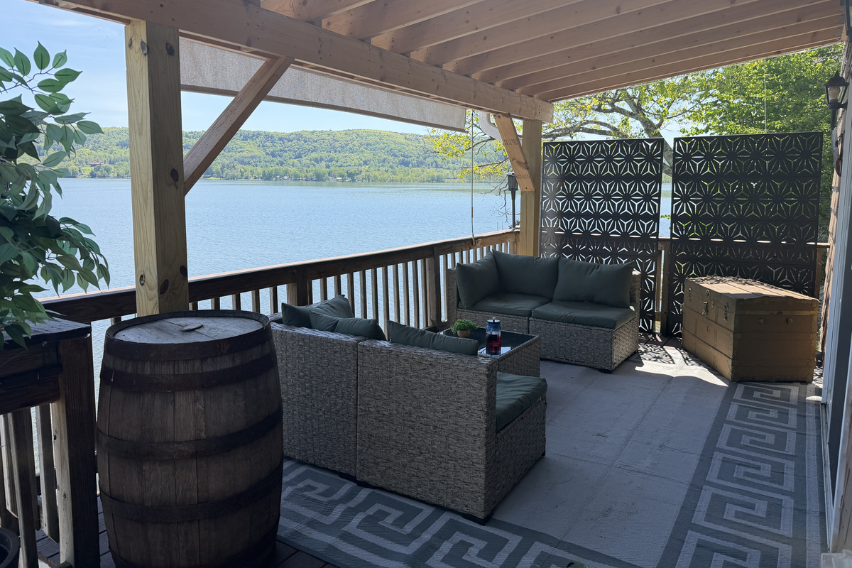 Covered lounge area on porch with pulldown sun shade