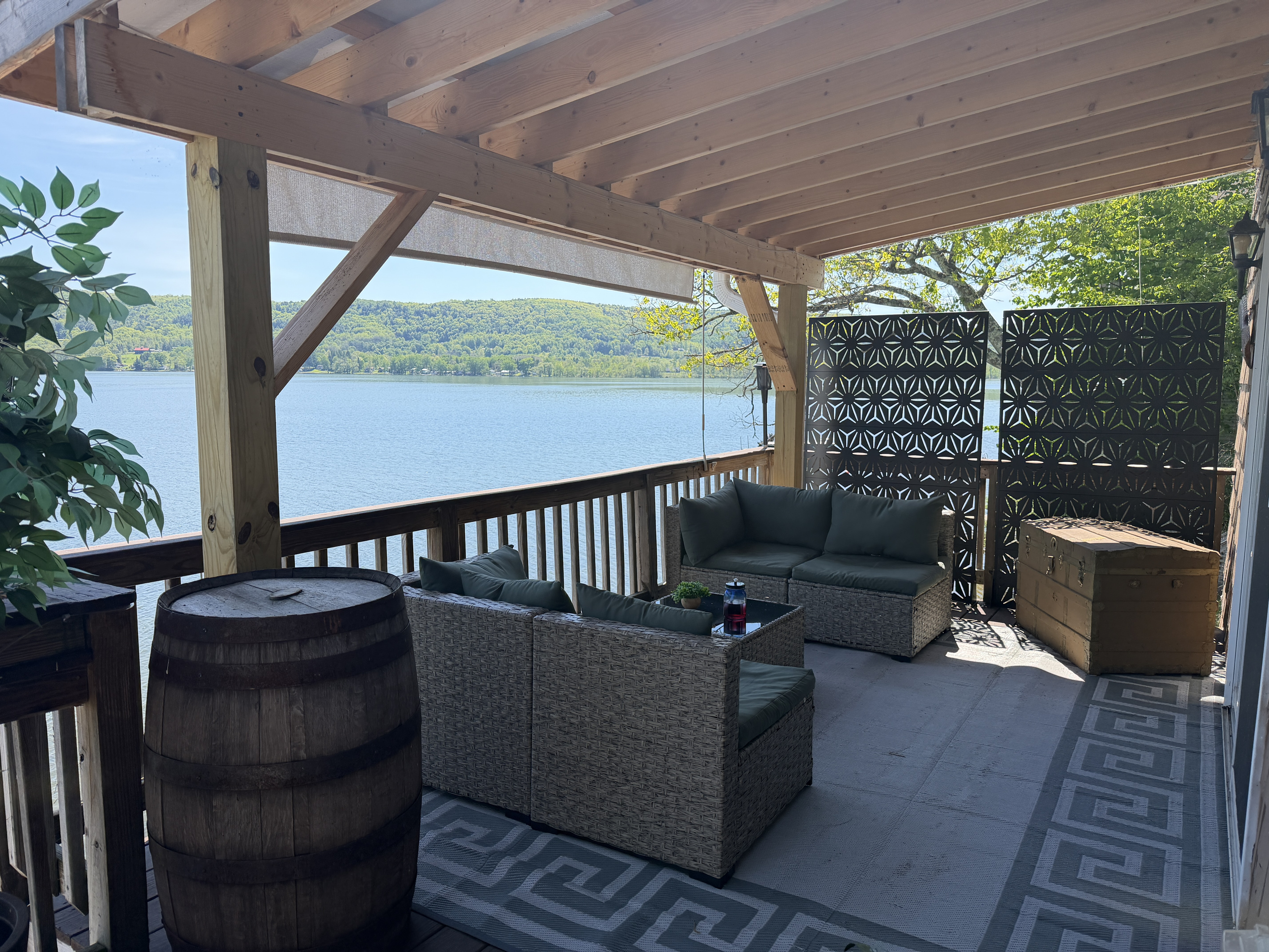 Covered lounge area on porch with pulldown sun shade