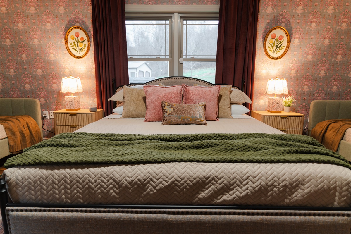 A spacious bedroom with a king bed and a comfortable setup for a good night’s sleep.
