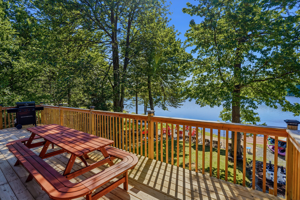 Upper deck with picnic table and open lake views — morning coffee never looked this good