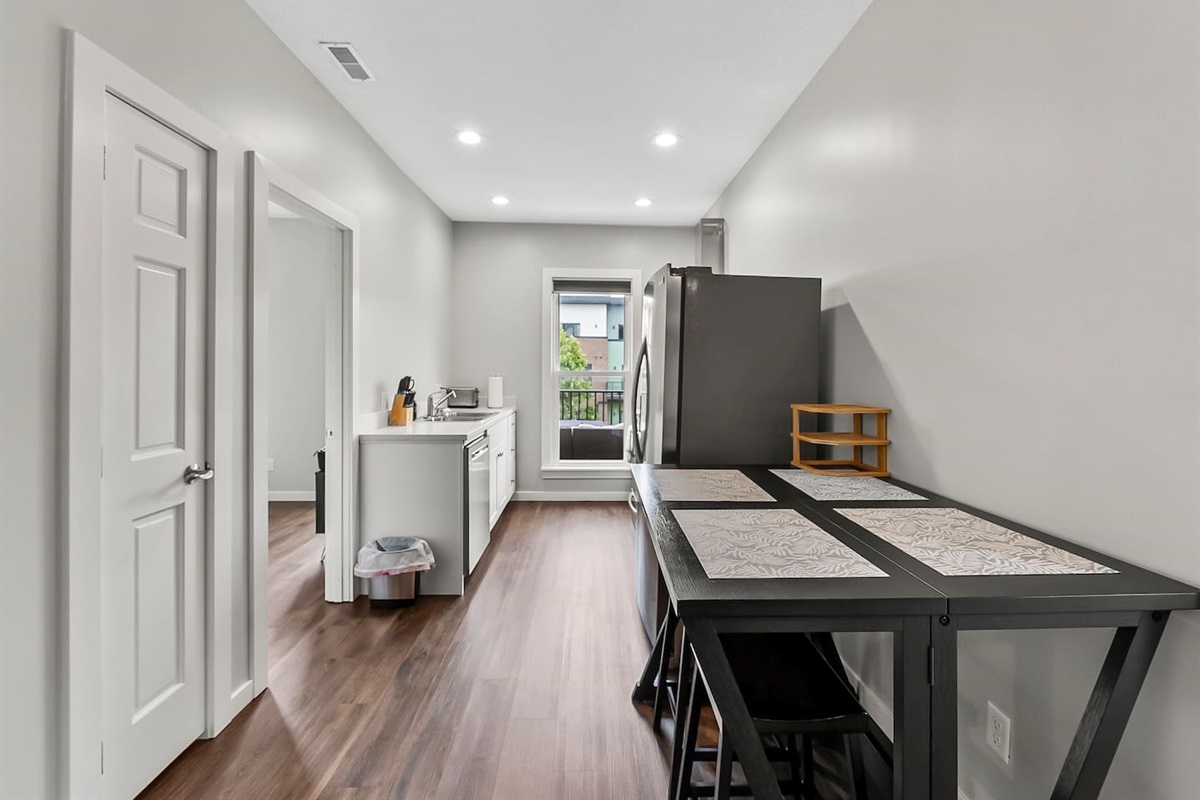 Minimalist dining corner that complements the kitchen and living area for easy flow and comfort.