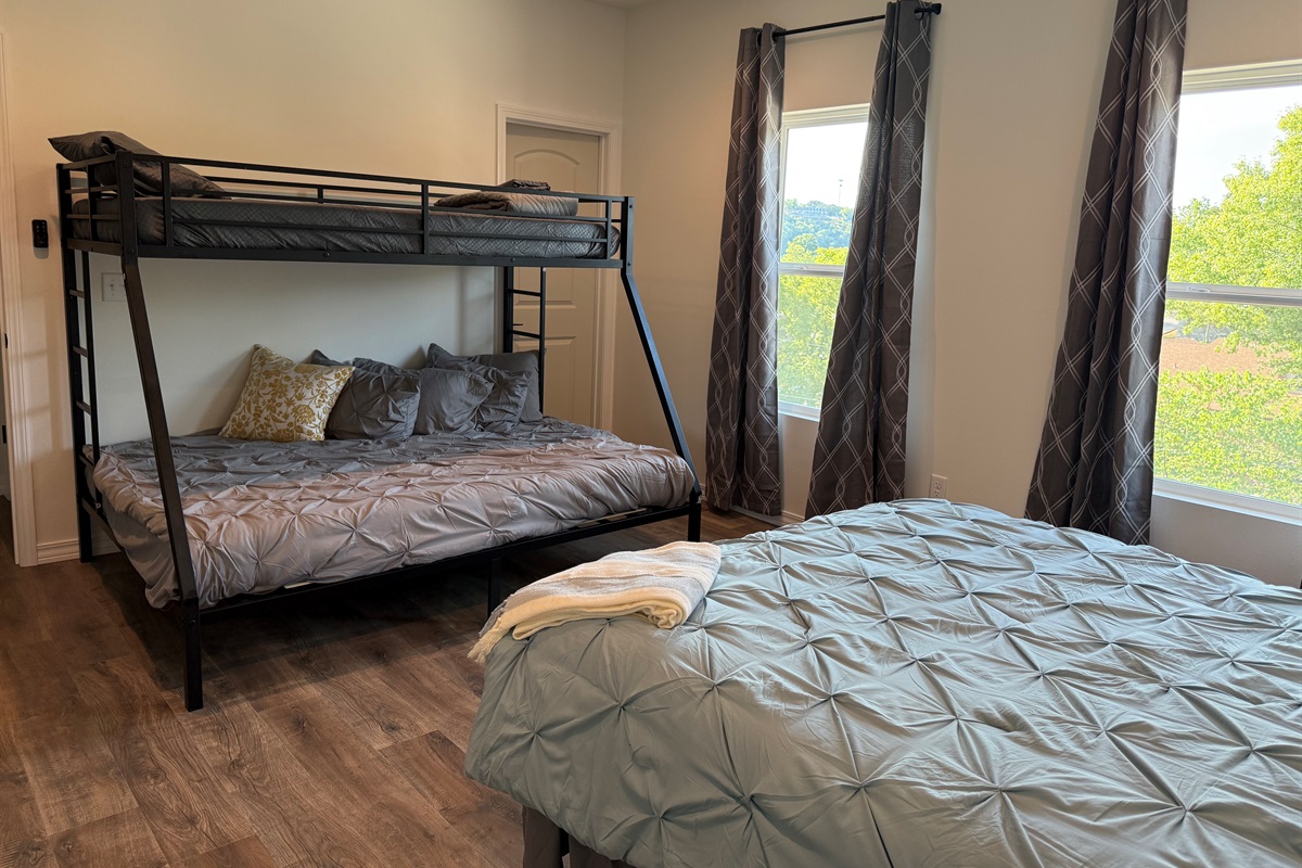 Bedroom #3 has a Queen bed and a set of Bunks. Lower bunk in a Queen and upper is a twin xl. Room is large enough to provide this amount of bedding and still have room to move around. Dresser and night stands also in room