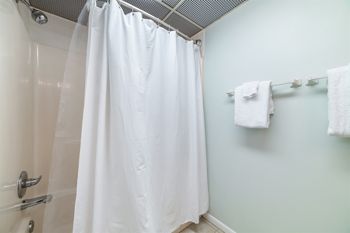 Freshly updated bathroom featuring a shower/tub combination, ample vanity space, and modern fixtures.
