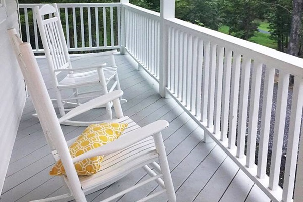 Rocking chairs on porch with mountain views