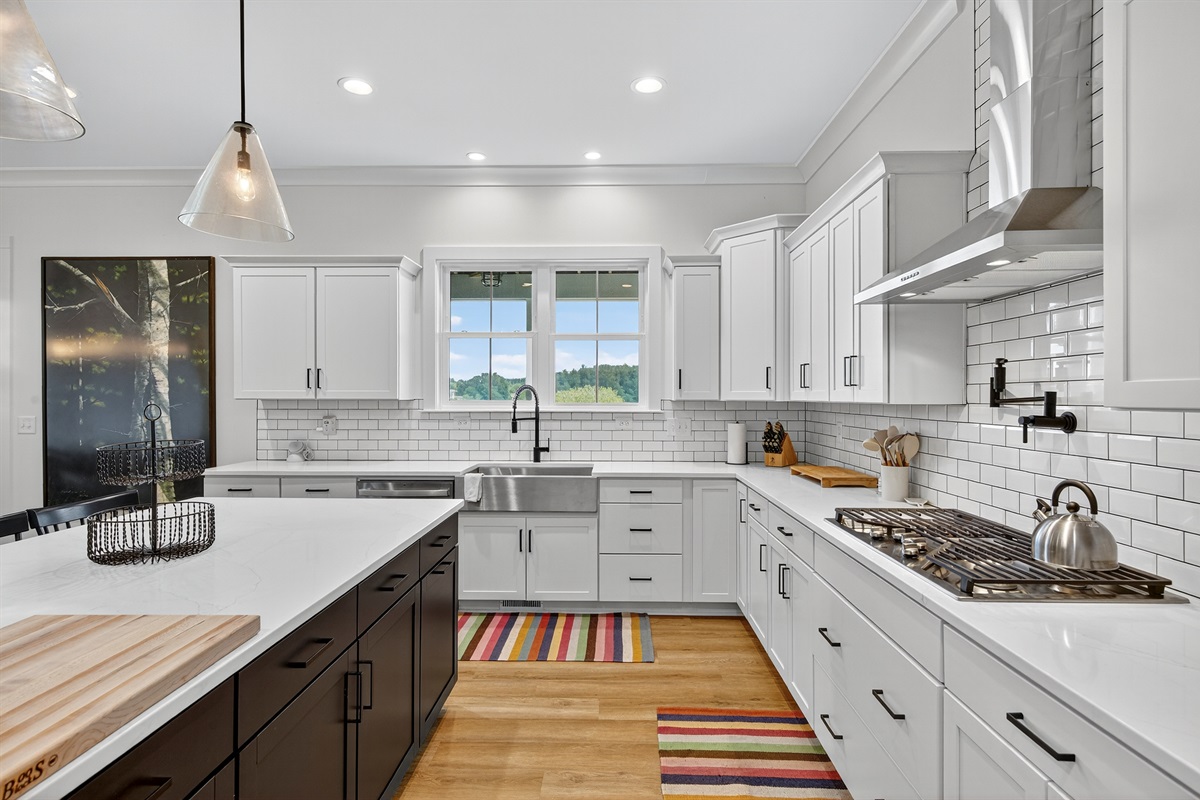 Cook like a chef in this fully equipped kitchen featuring a large center island, gas cooktop, and double ovens.