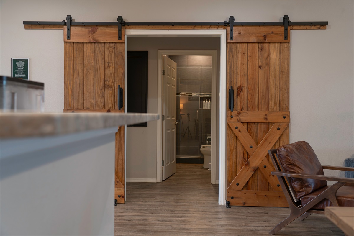 The family shower room is right off the living room with Queen Rm1 & 2 either side 