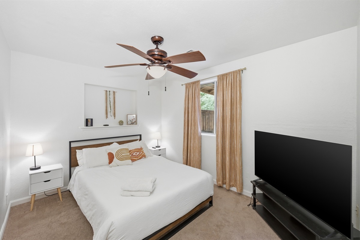 Chic and cozy, this sun-filled bedroom features soft neutrals, modern decor, and a peaceful ambiance perfect for a restful night's sleep.