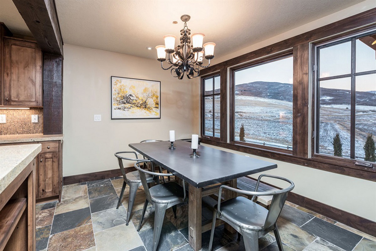 Sunlit dining with panoramic vistas and designer lighting, blending comfort and elegance for both intimate dinners and lively gatherings.