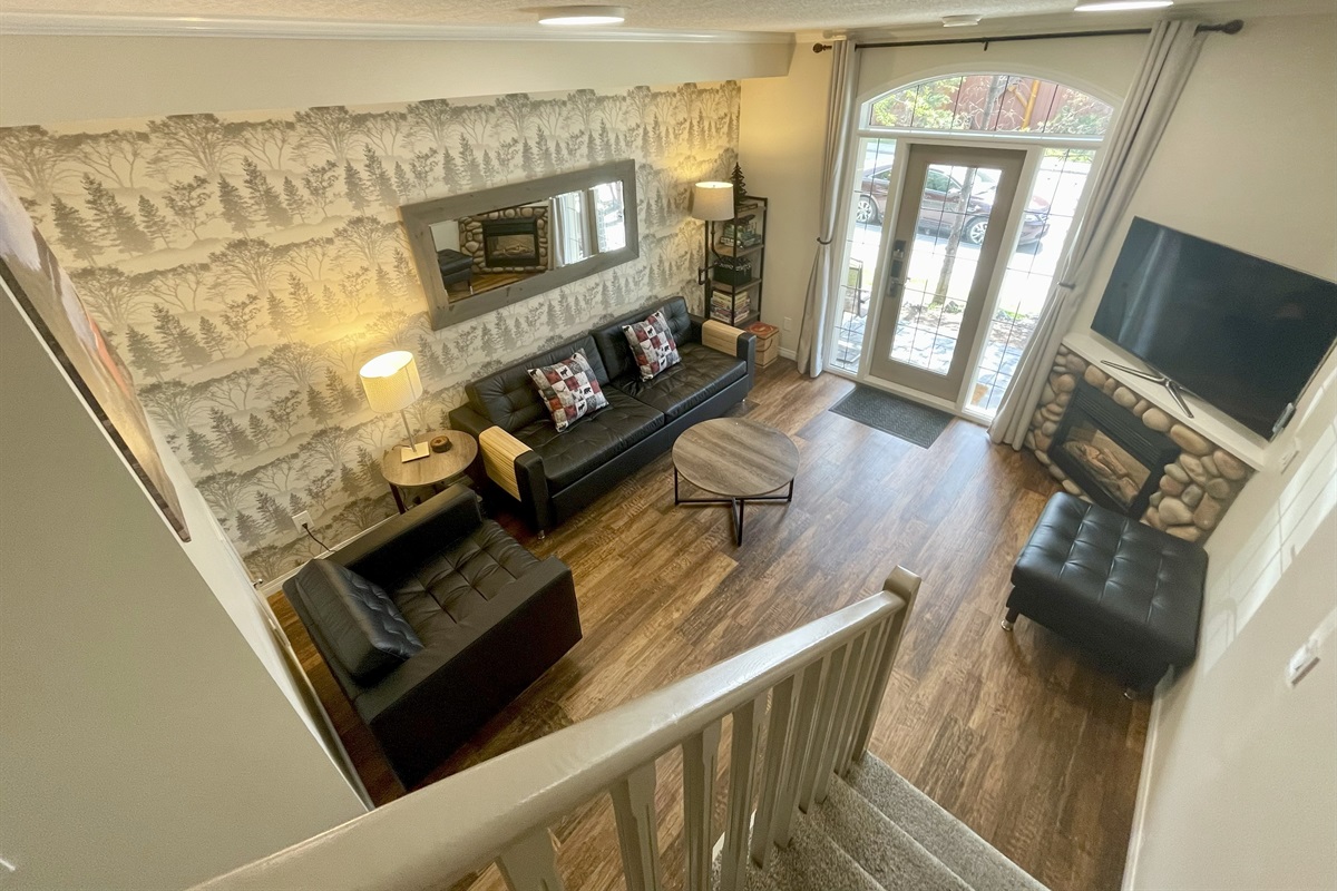 Fireplace and TV in the living room. Walk outside to your patio with a view of the mountains.
