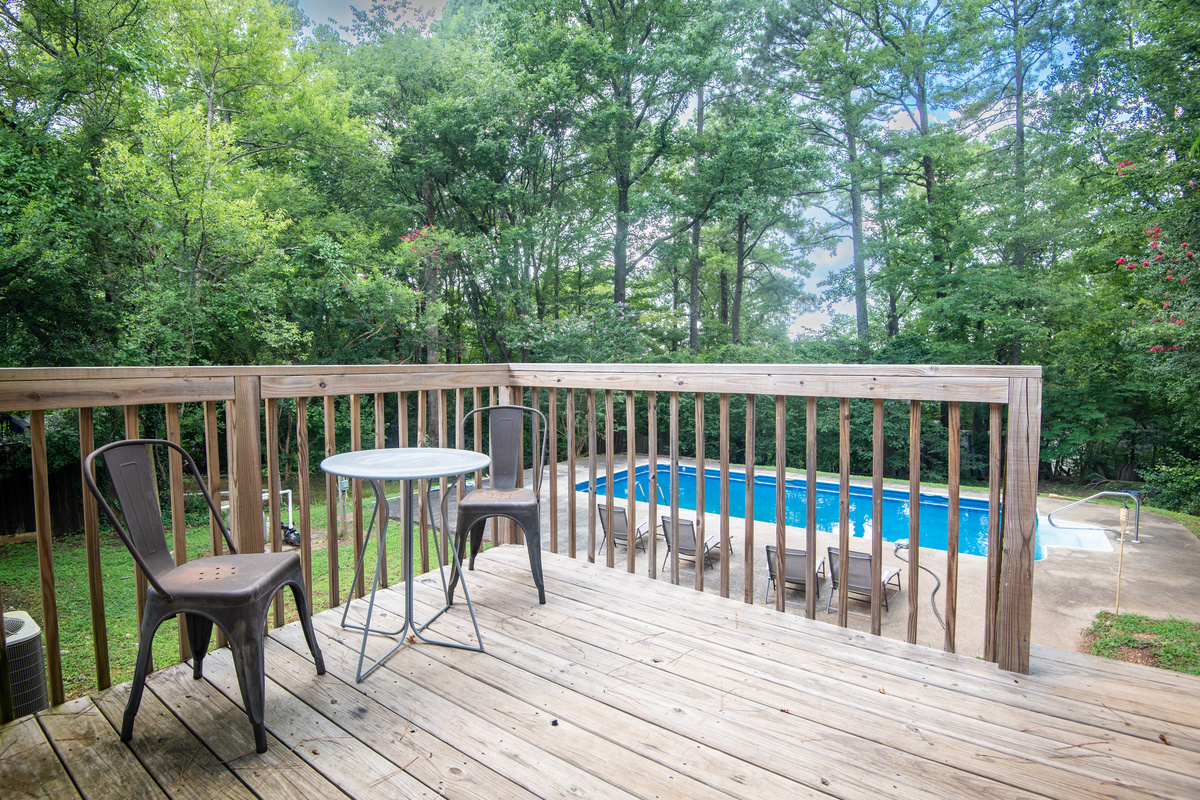 Start your morning with a cup of coffee overlooking the pool or wind down here after a day of swimming. This peaceful back porch is the perfect spot to slow down and enjoy the view.
