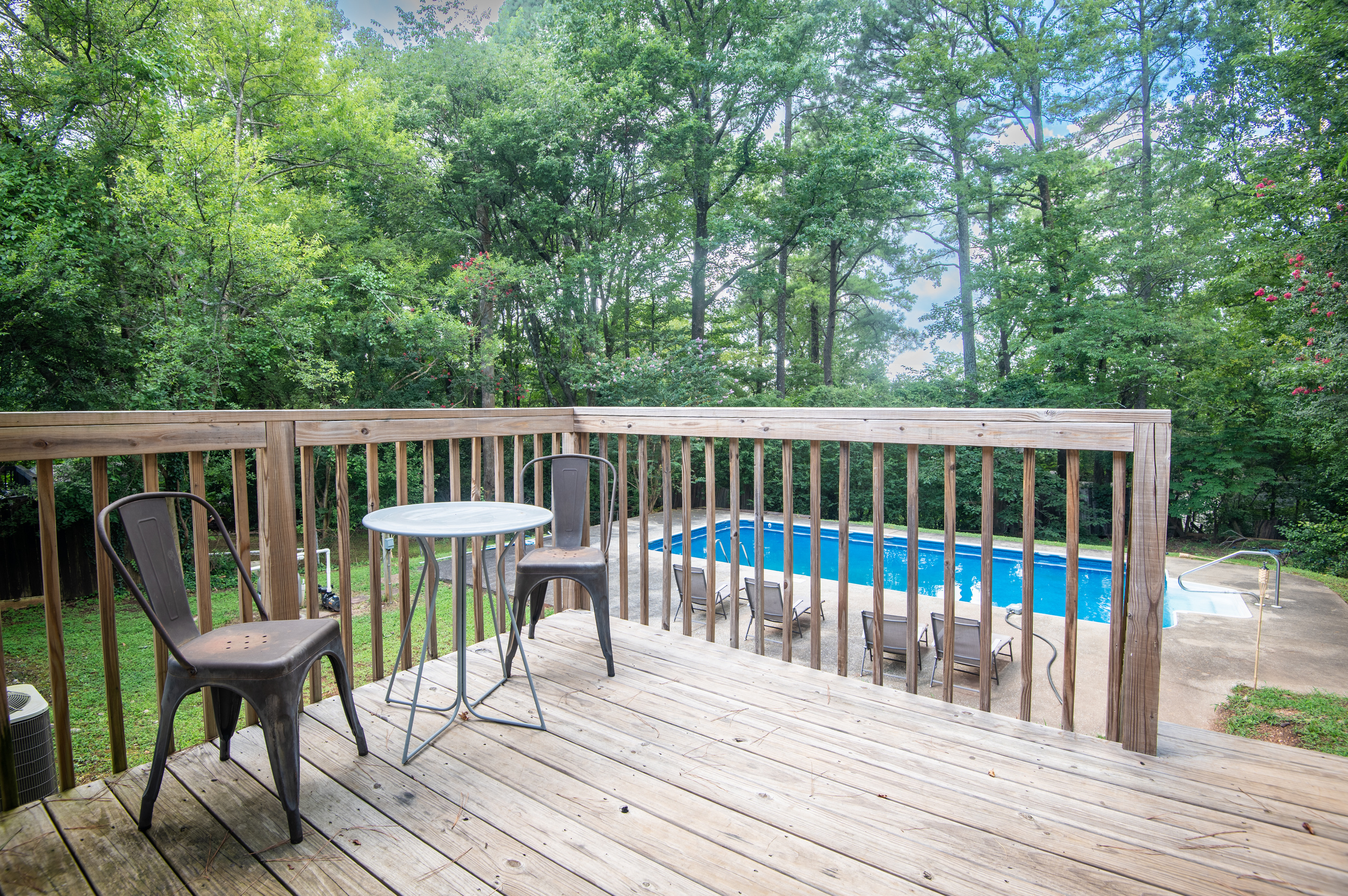 Start your morning with a cup of coffee overlooking the pool or wind down here after a day of swimming. This peaceful back porch is the perfect spot to slow down and enjoy the view.