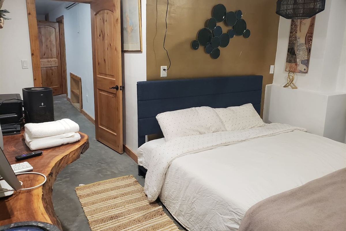 Bedroom 6 with sliding door walkout access from basement and ensuite bathroom. Live edge desk. 