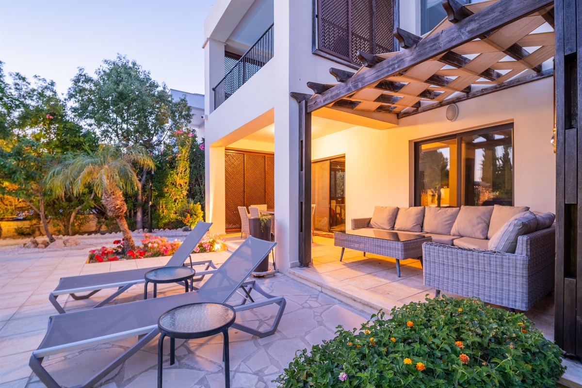 Spacious patio with cozy outdoor seating, sun loungers, and vibrant greenery. Enjoy warm evenings under the wooden pergola or dine al fresco in one of the garden dining areas.