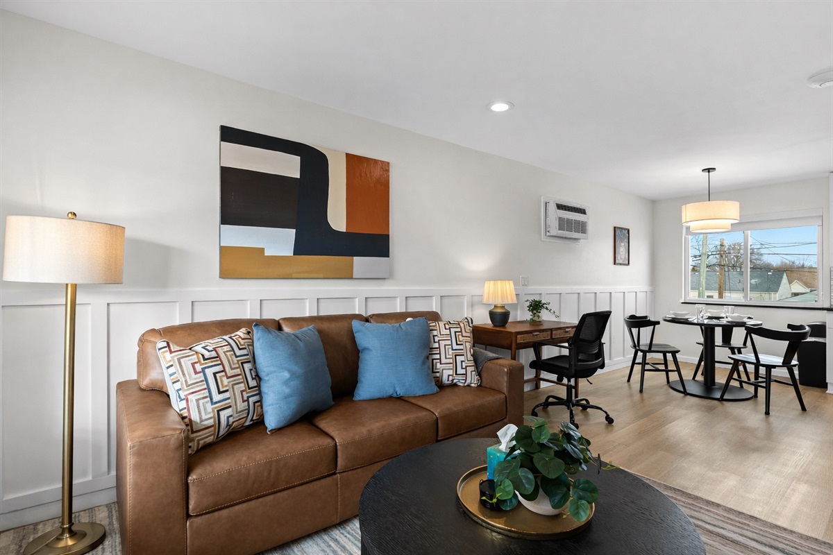 Inviting open living space with cozy seating, stylish décor, dining area, and a dedicated workspace—perfect for relaxing, working, and unwinding.